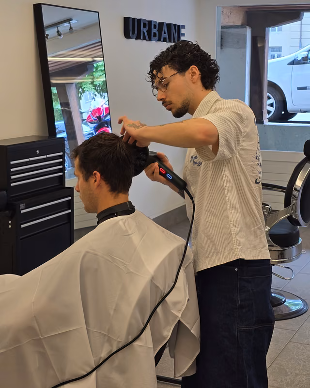Adrian styling a client's hair at URBANE